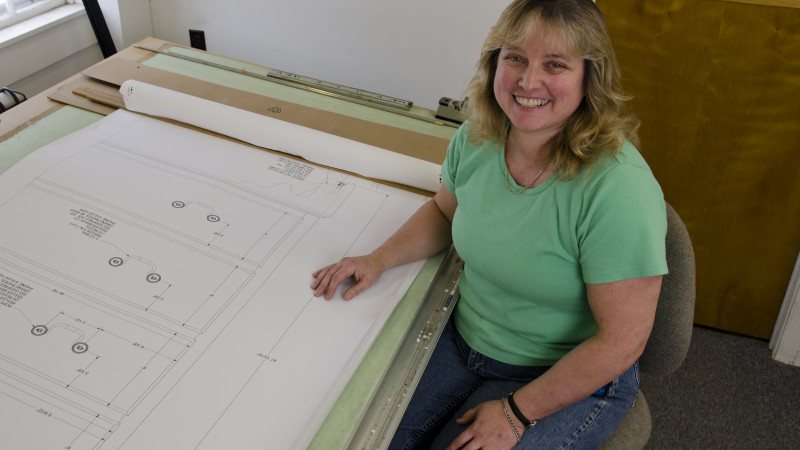 Female student sits at drafting table