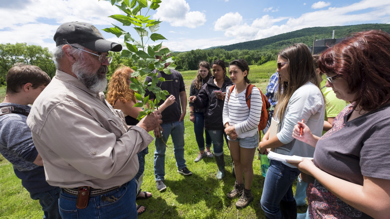 Teacher speaking to Forest ecology class outdoors