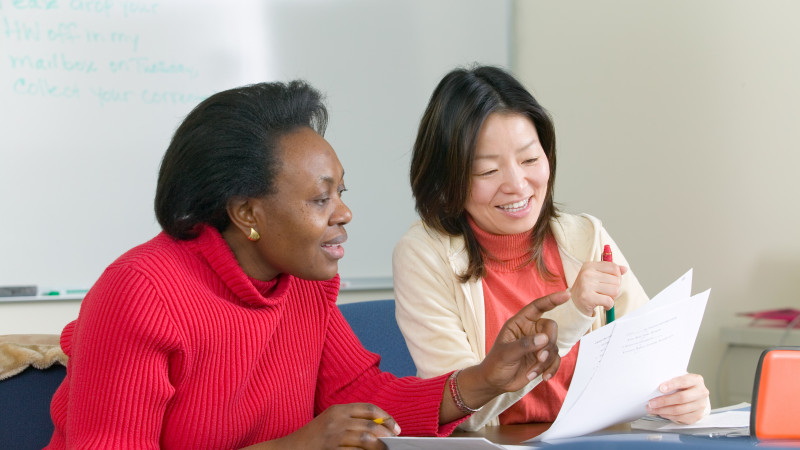 two people looking at a document