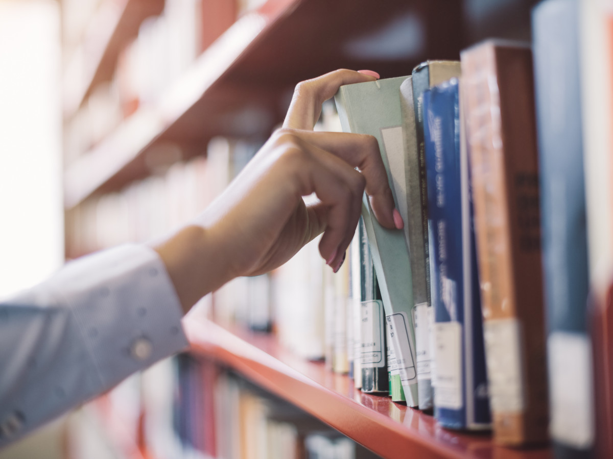 person Selecting Book