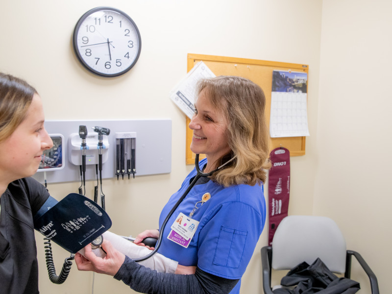 Medical assistant taking someone's blood pressure