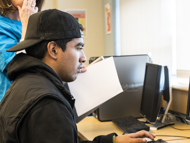 Student at computer with instructor