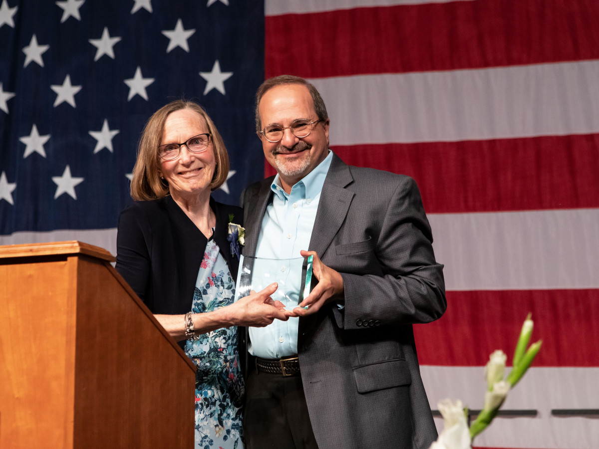 Joyce Judy presents Steve Gordon with CCV's community services award.