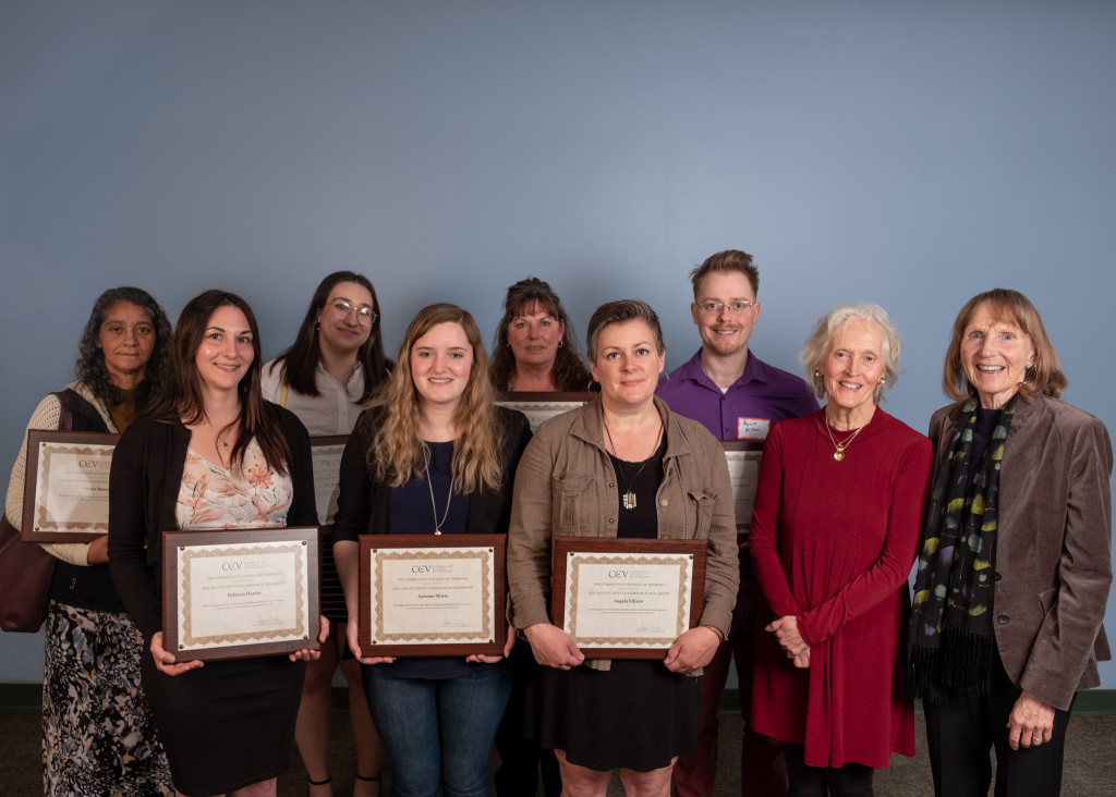 Group of students with plaques